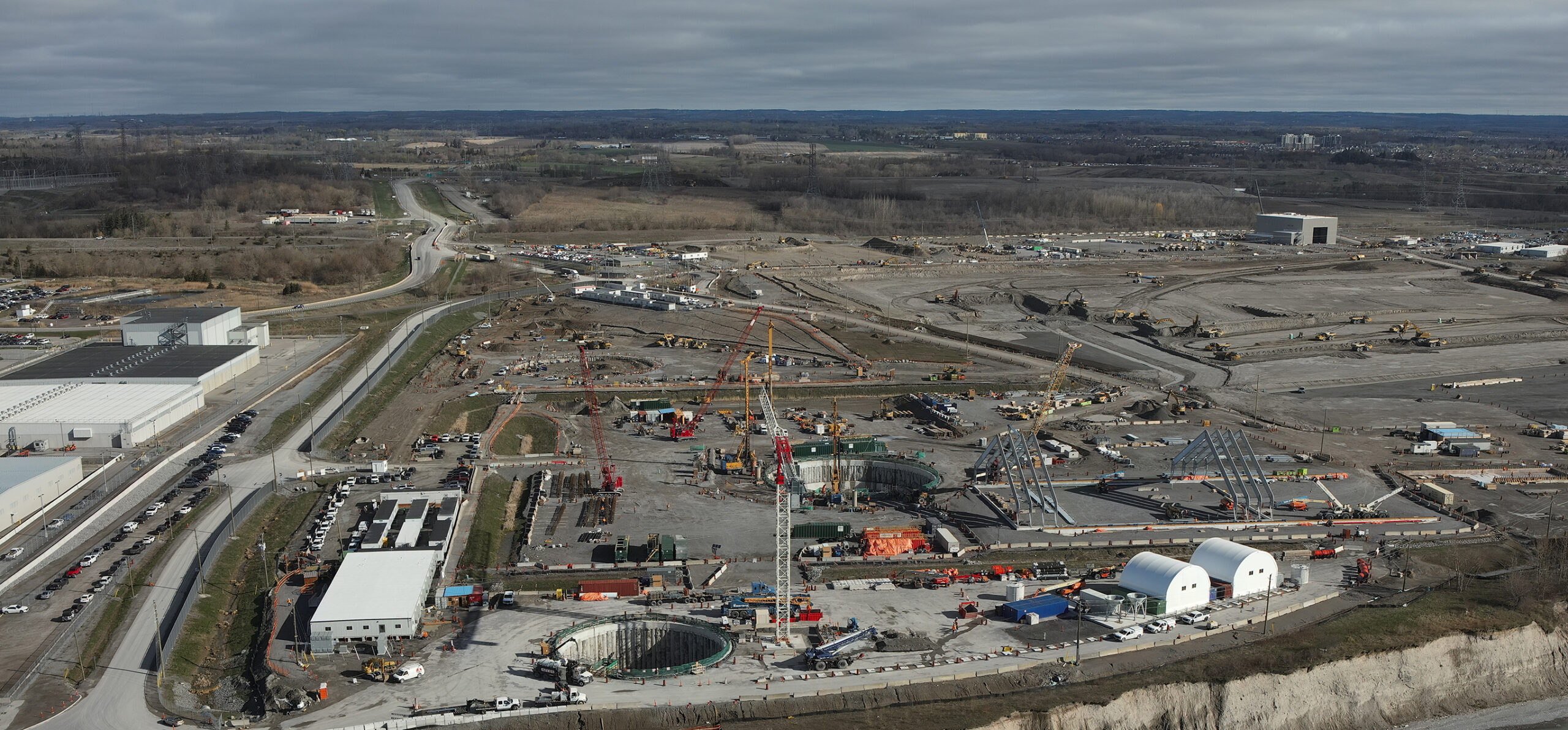 The Darlington New Nuclear Project site, future home of North America's first grid-scale Small Modular Reactor (SMR). Ontario Power Generation (OPG) has begun excavation and component staging for the first GE Hitachi BWRX-300 unit, slated to enter commercial service by 2030. Source: OPG